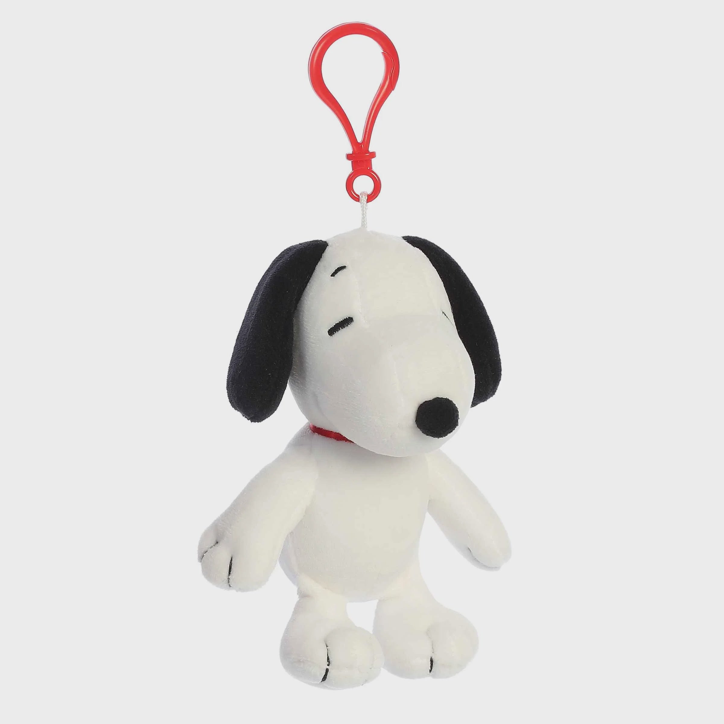 Plush Snoopy bag charm with a red clip on a white background