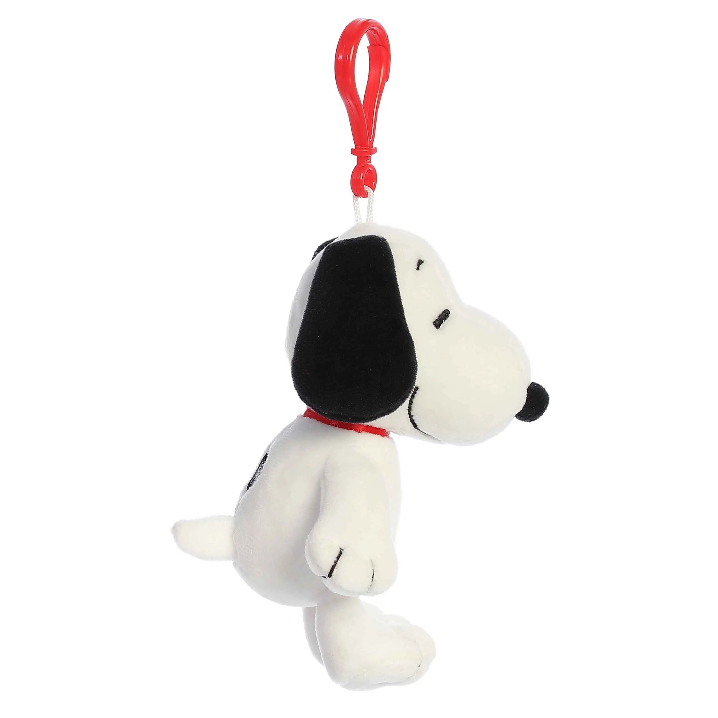 Plush Snoopy bag charm with a red clip on a white background