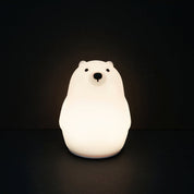 Polar bear-shaped night light on a black background