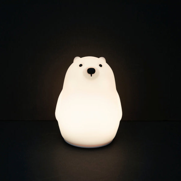 Polar bear-shaped night light on a black background