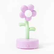 Flower-shaped night light with a pink flower and green stem on a white background