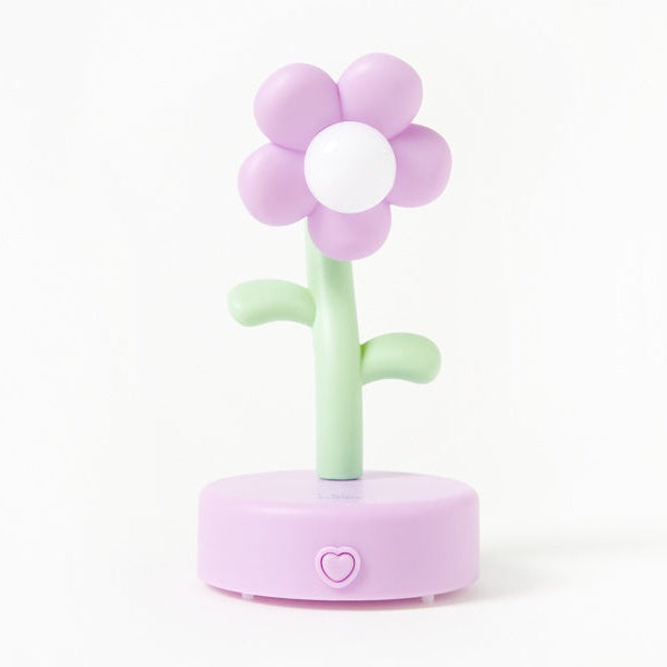 Flower-shaped night light with a pink flower and green stem on a white background