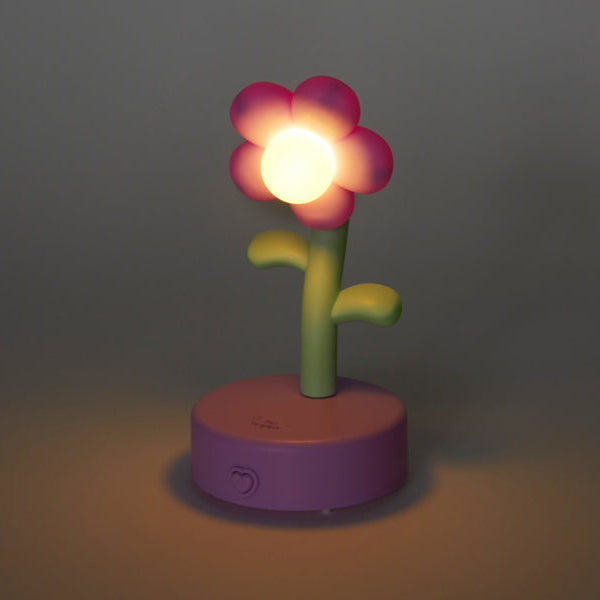 Flower-shaped night light with a glowing bulb on a dark background