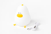 White chicken-shaped mood light with a yellow beak on a white background