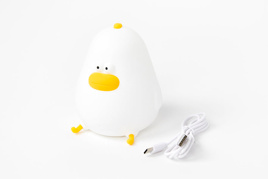 White chicken-shaped mood light with a yellow beak on a white background