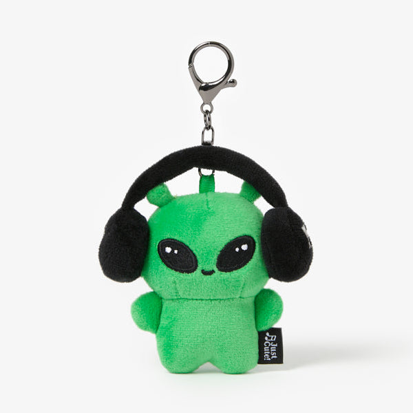 Green alien plush toy with black headphones on a white background