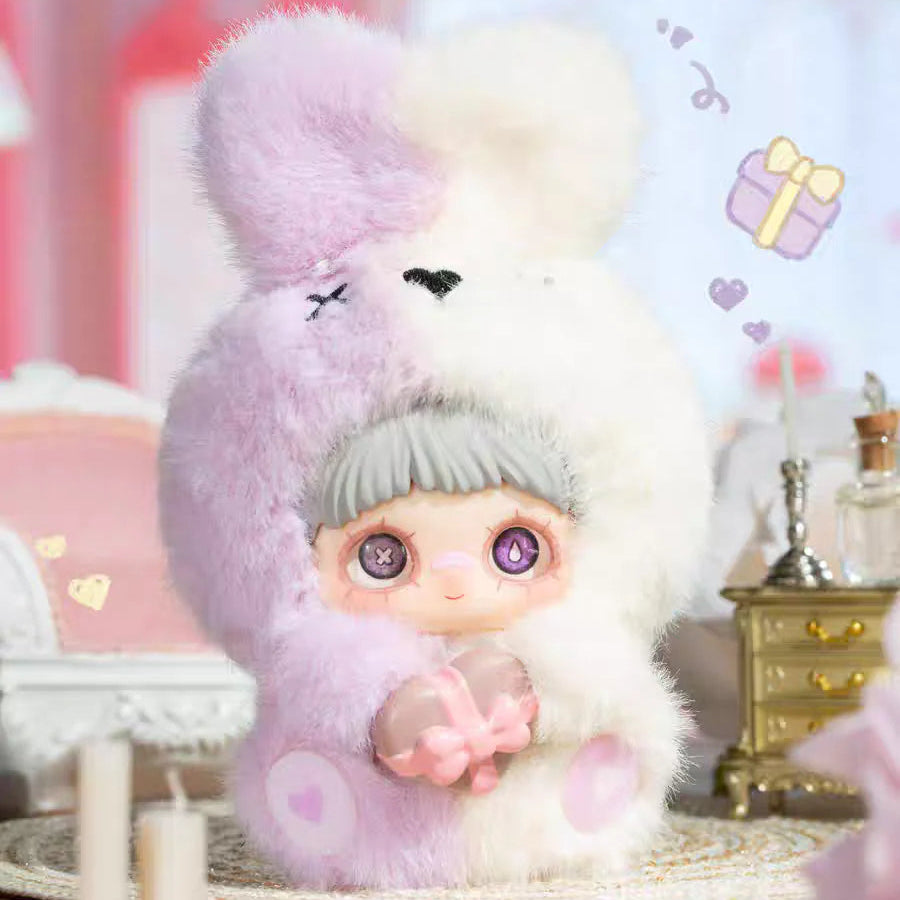 Stuffed animal toy with a character wearing a hat and scarf, surrounded by decorative elements.