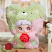 Plush toy with a doll face holding a red flower, labeled 'Wild Rose'.