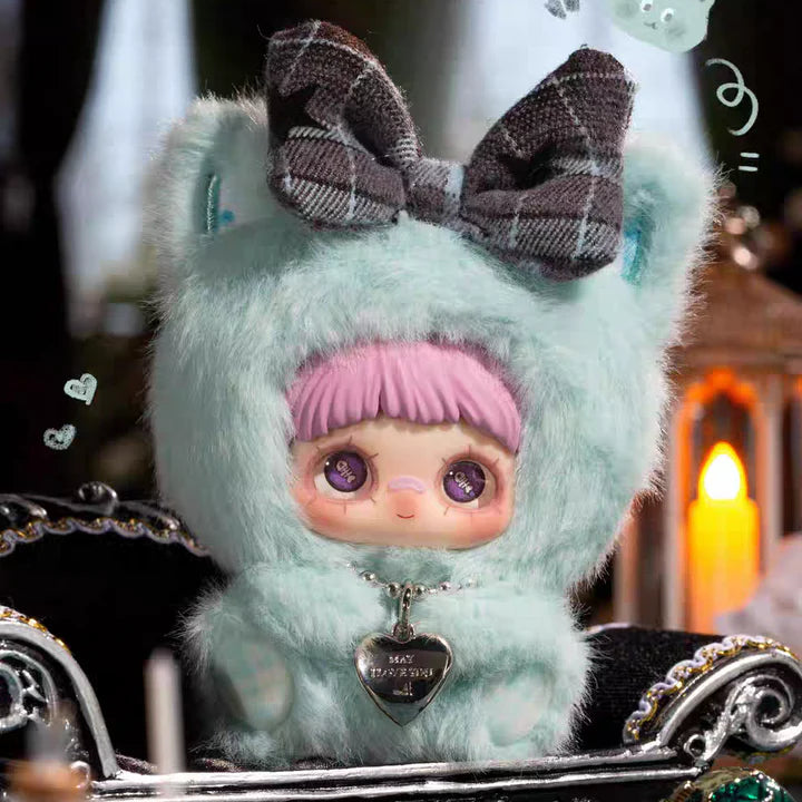 Toy figure with a plaid bow and pink headband in a decorative setting with 'No More Tears' text.