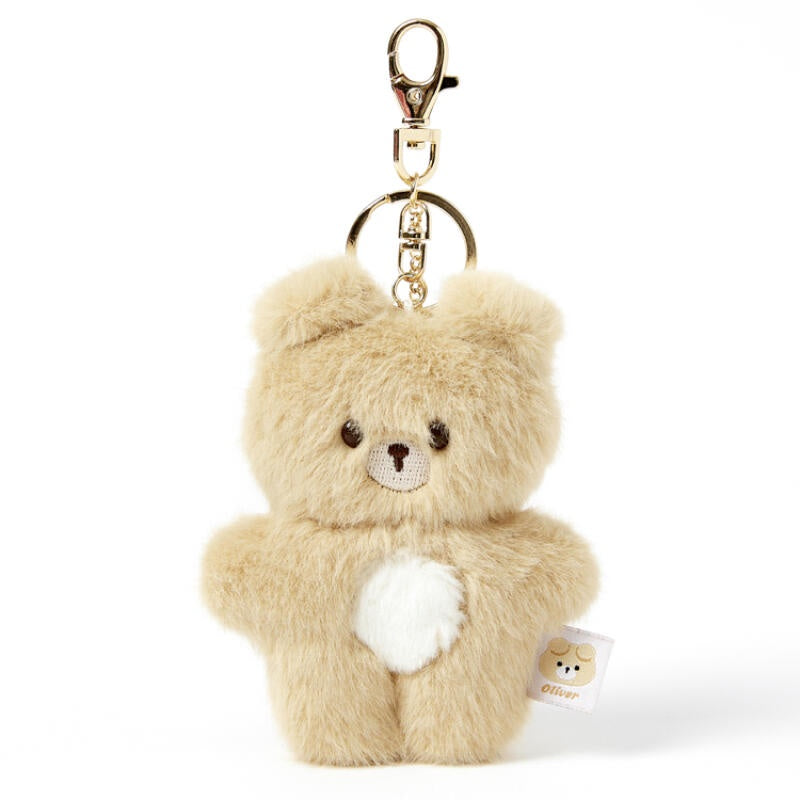 Beige teddy bear keychain with a gold clasp on a white background