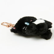 Black and white plush keychain on a white background