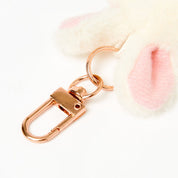 Rose gold keychain on a soft, blurred background