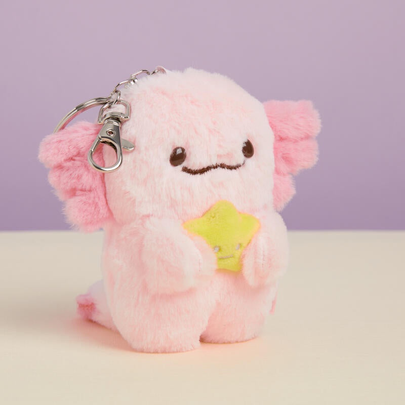 Pink plush keychain with a star on a light purple background
